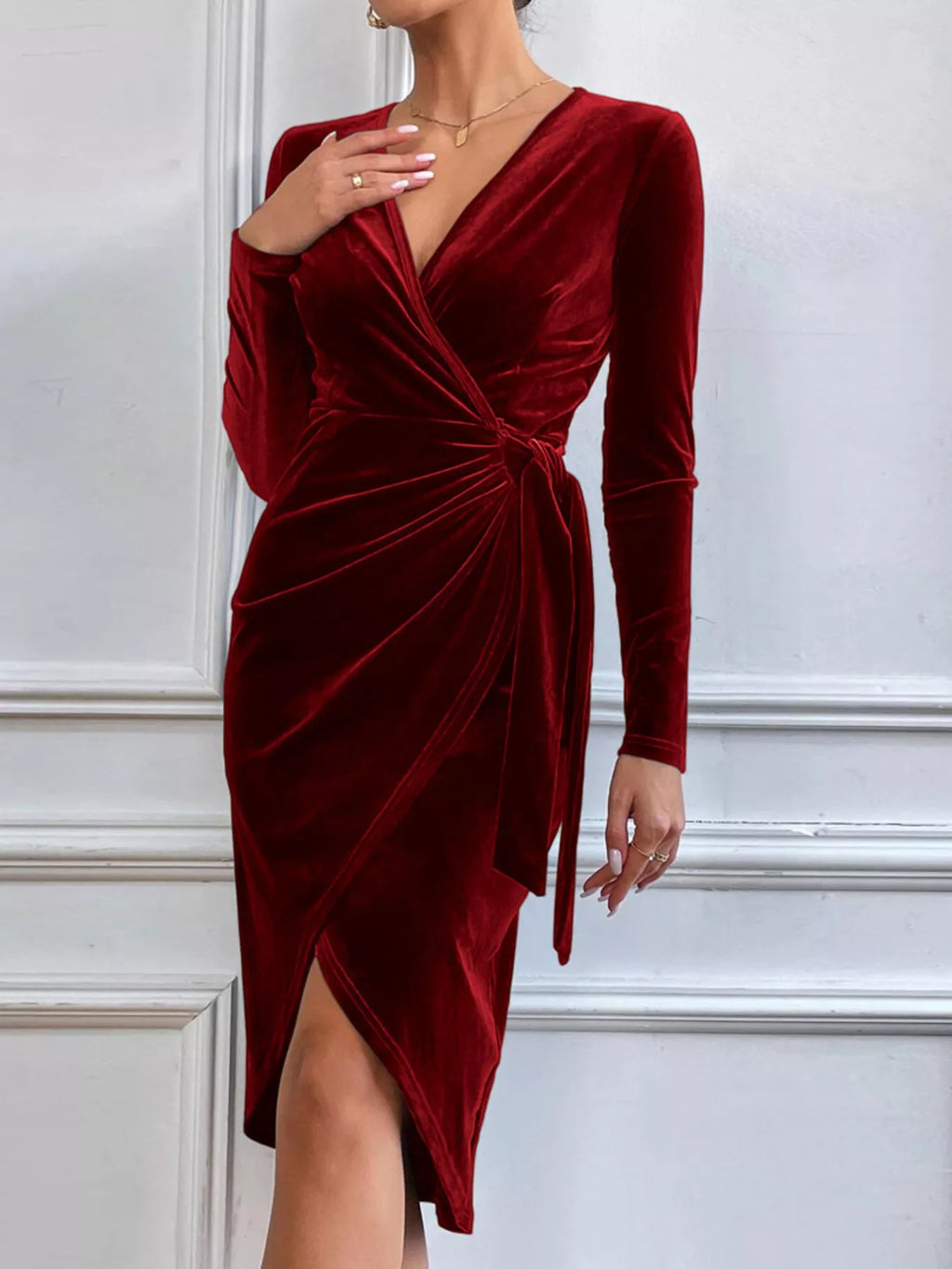 Wine red long-sleeve velvet midi dress with a draped front and asymmetric slit.