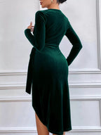 Dark green long-sleeve velvet midi dress, back view.